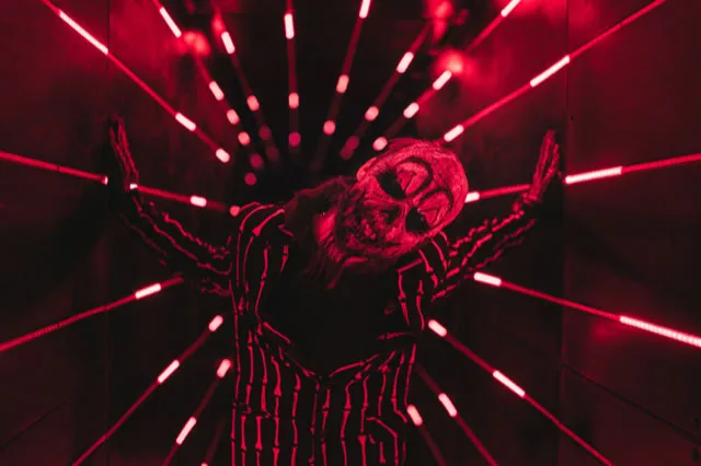 Costumed performer in a lit tunnel at Fear Farm